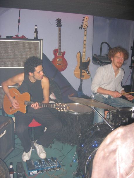 photo of drummer and guitarist jamming at the white cat club