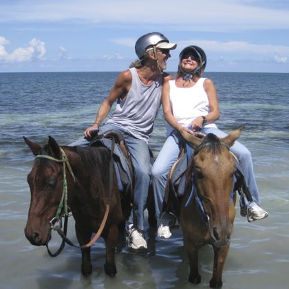 Andy and Barbara laughing on horses in Jamaica, October 2013