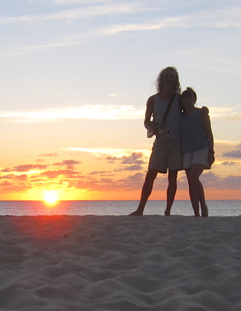 picture of Andy & Barbara on a beach in Anguilla in front of a sunset